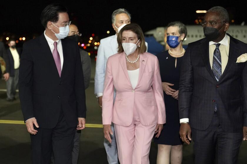 U.S. House Speaker Nancy Pelosi walks with Taiwan's Foreign Minister Joseph Wu