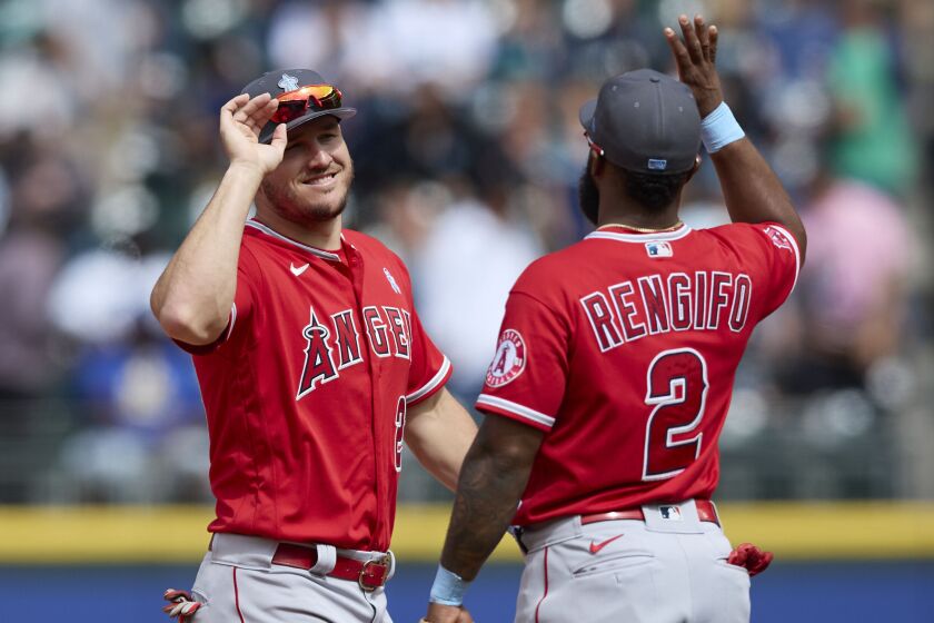 Los Angeles Angels' \Mike Trout and Luis Rengifo celebrate a win over the Seattle Mariners.