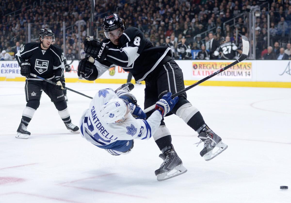Kings defenseman Drew Doughty upends Maple Leafs center Mike Santorelli with a big hit in the first period of Los Angeles' 2-0 win.