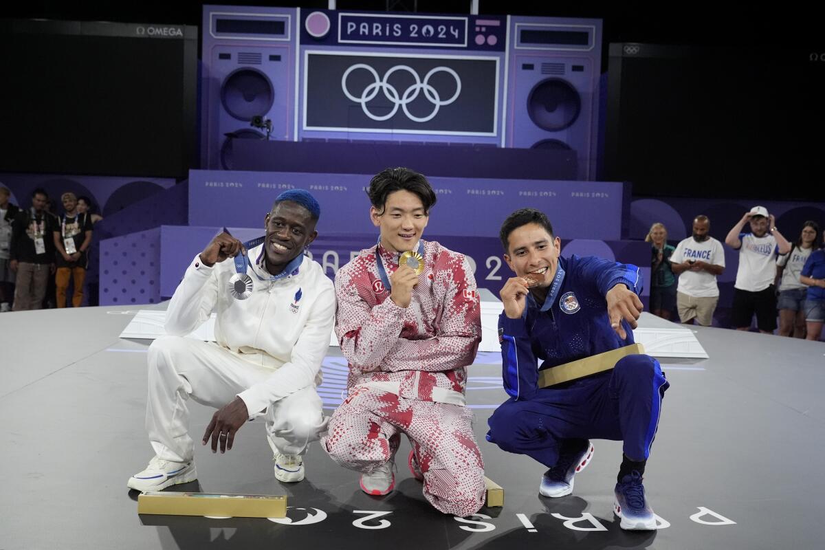 Canadian B-Boy Phil Wizard poses with French B-Boy Dany Dann and American B-Boy Victor after they won breaking medals