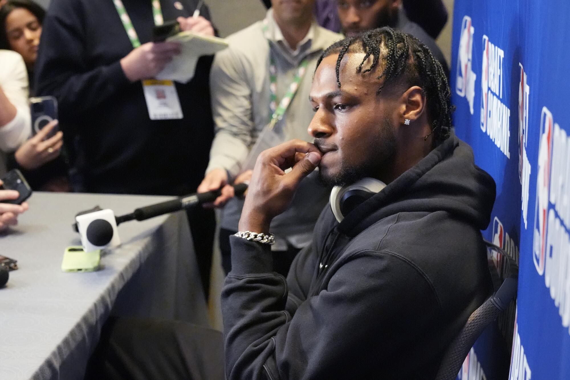 Bronny James bites on a finger nail as he listens to a reporter's question during his draft combine media session Tuesday.