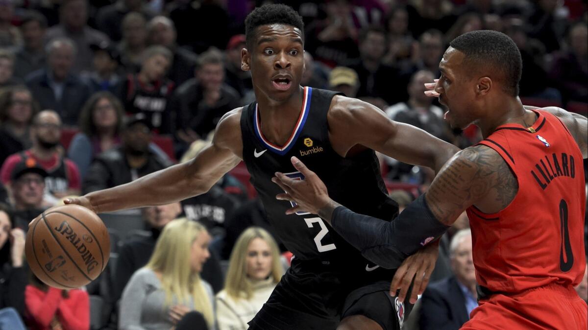 Clippers guard Shai Gilgeous-Alexander, left, tries to get past Portland's Damian Lillard during a Nov. 8 game.
