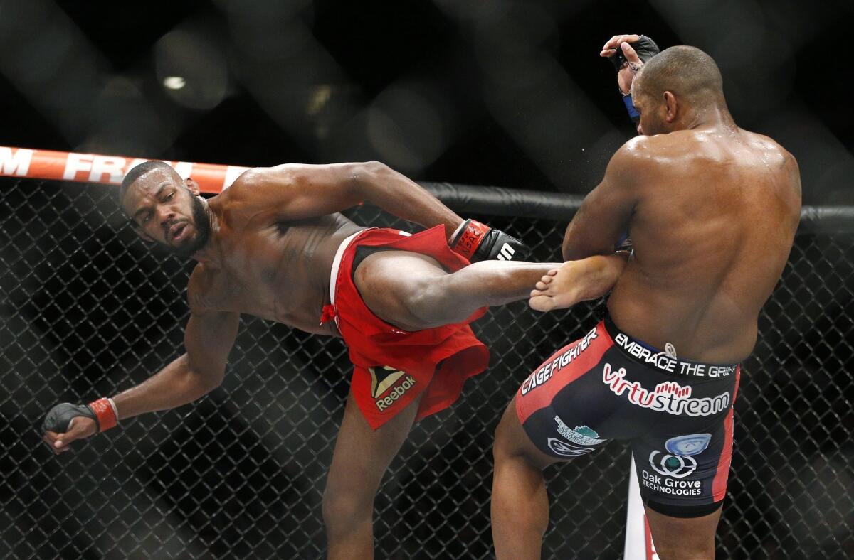 Jon Jones kicks Daniel Cormier during their light heavyweight title mixed martial arts bout at UFC 182 on Jan. 3, 2015.