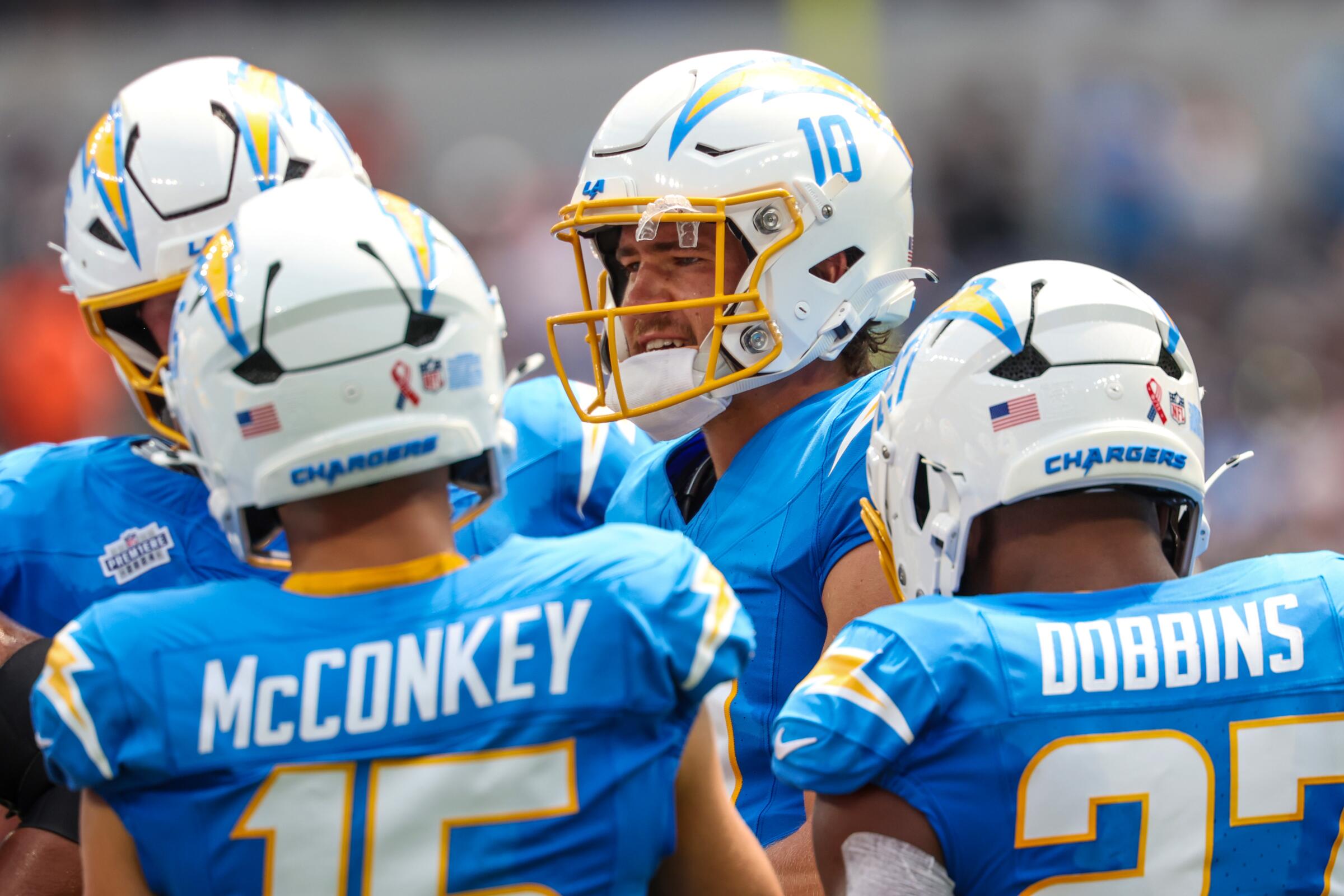 Chargers quarterback Justin Herbert (10) talks during a huddle against the Las Vegas Raiders at SoFi Stadium.