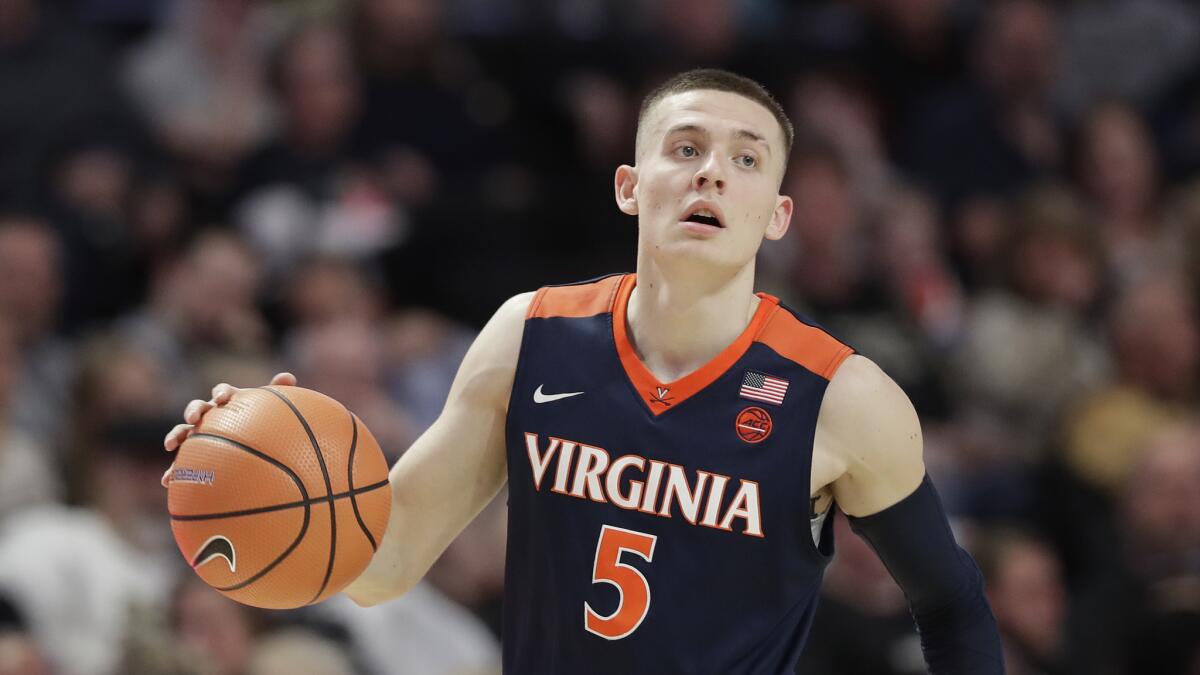 Virginia's Kyle Guy (5) brings the ball up the court against Wake Forest during the second half.