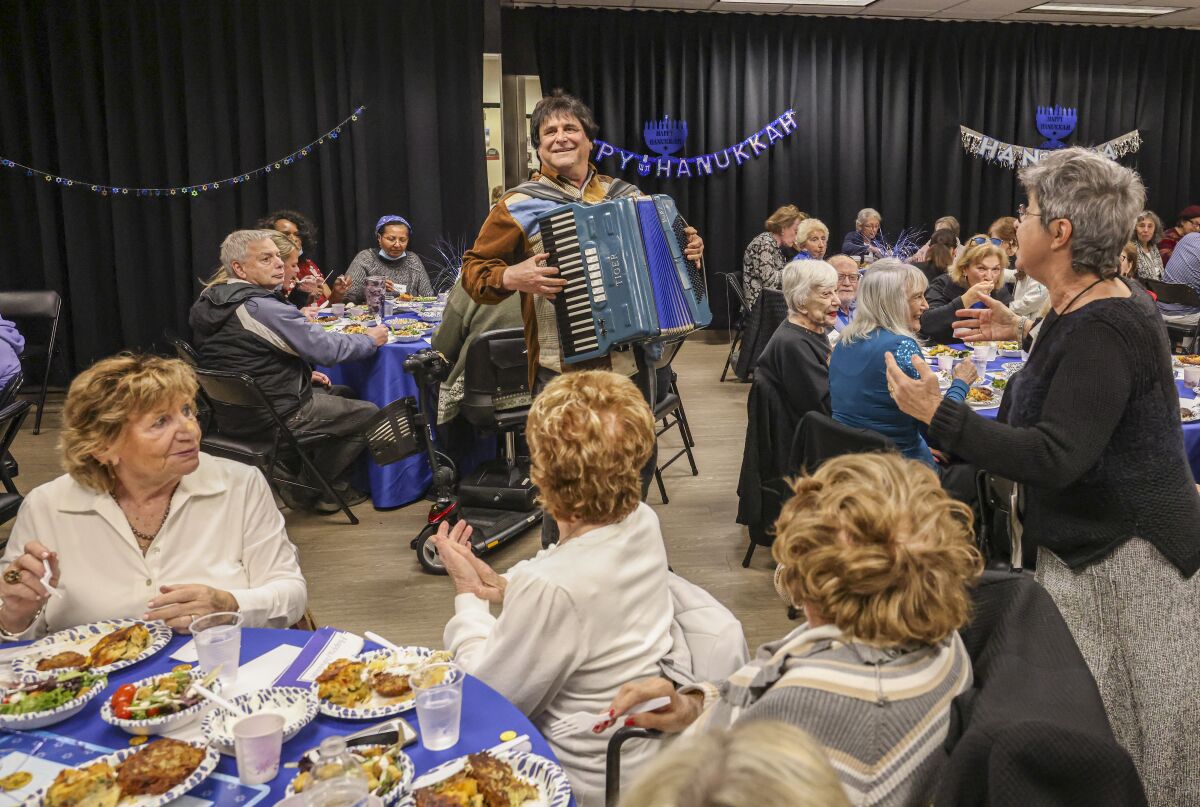 Accordionist Shalom Sherman plays during a Hanukkah celebration at the Lawrence Family Jewish Community Center in La Jolla.