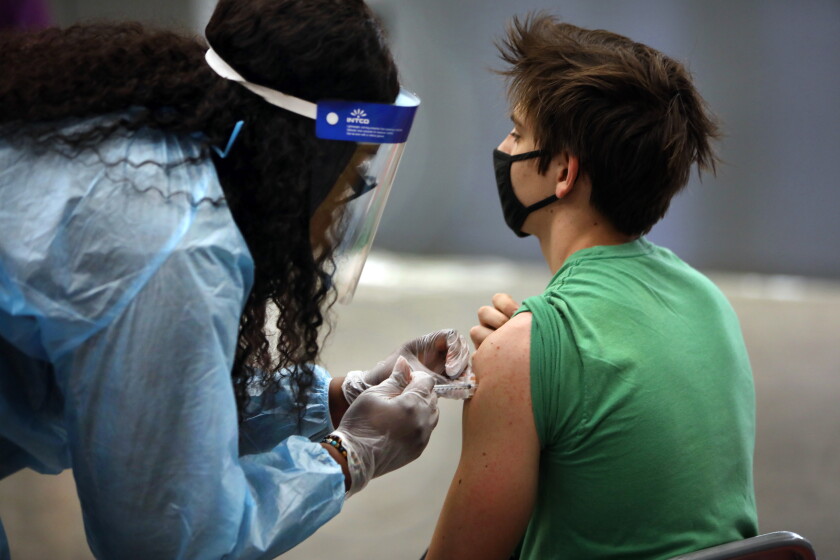My family is divided over COVID-19 vaccinations. Here's how
we cope 7 San Pedro—May 24, 2021—Visiting nurse Latasha Hall, of New Orleans administers that vaccine to a student at San Pedro Senior High school on May 24, 2021. San Pedro Senior High school is one of the Los Angeles County Unified schools providing coronavirus vaccines for children 12 and up. (Carolyn Cole / Los Angeles Times)
