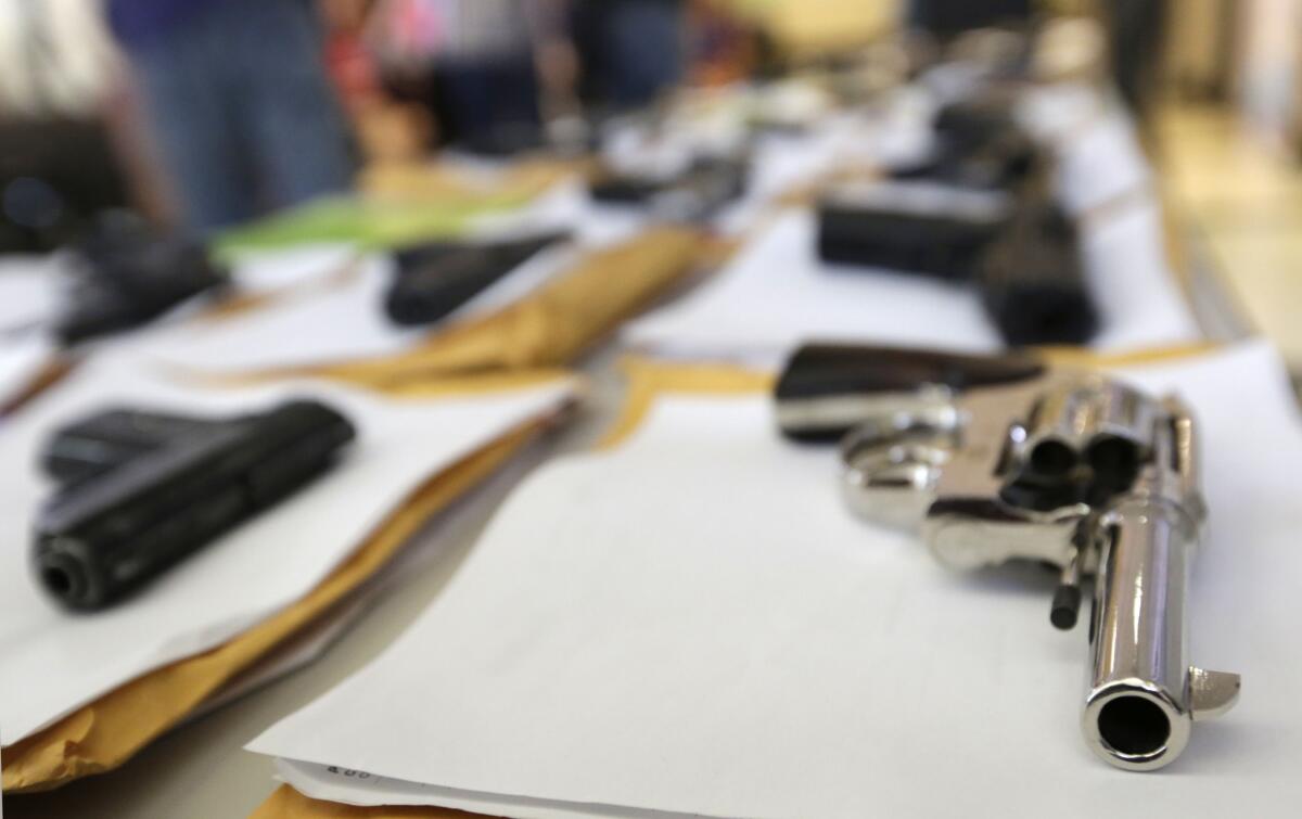 Chicago police display some of the thousands of illegal firearms they confiscated in their battle against gun violence in Chicago in 2014.