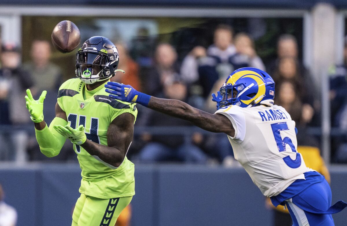 Seattle Seahawks wide receiver DK Metcalf makes a reception as Rams defensive back Jalen Ramsey defends.