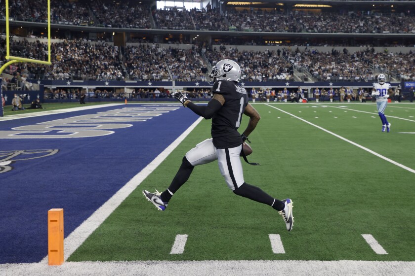 Las Vegas Raiders wide receiver DeSean Jackson sprints to the end zone after catching a pass for a touchdown in the first half of an NFL football game against the Dallas Cowboys in Arlington, Texas, Thursday, Nov. 25, 2021. (AP Photo/Michael Ainsworth)