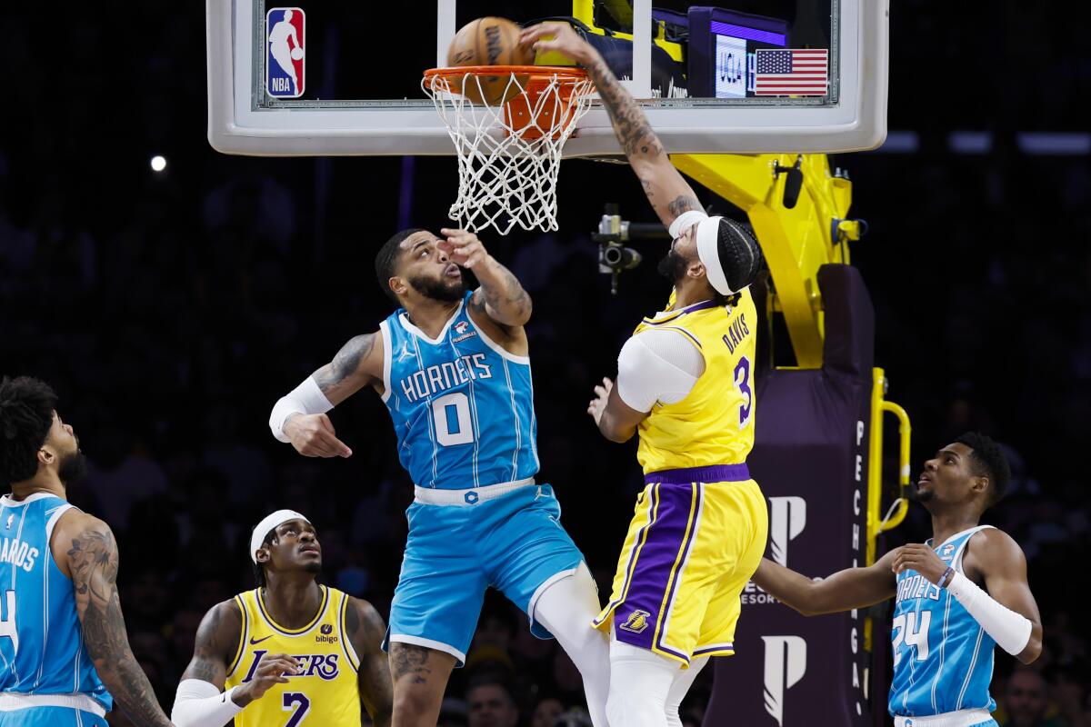 Lakers forward Anthony Davis dunks over Charlotte Hornets forward Miles Bridges.