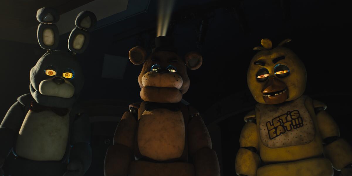 Three robots in a scene from "Five Nights at Freddy's."