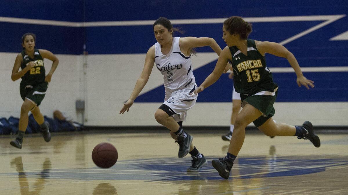 Newport Harbor High’s Lexi Alvarez (2) starts a fast break after a stealing the ball during the first half against Rancho Alamitos in a Hawk Holiday Classic game in Huntington Beach on Wednesday.