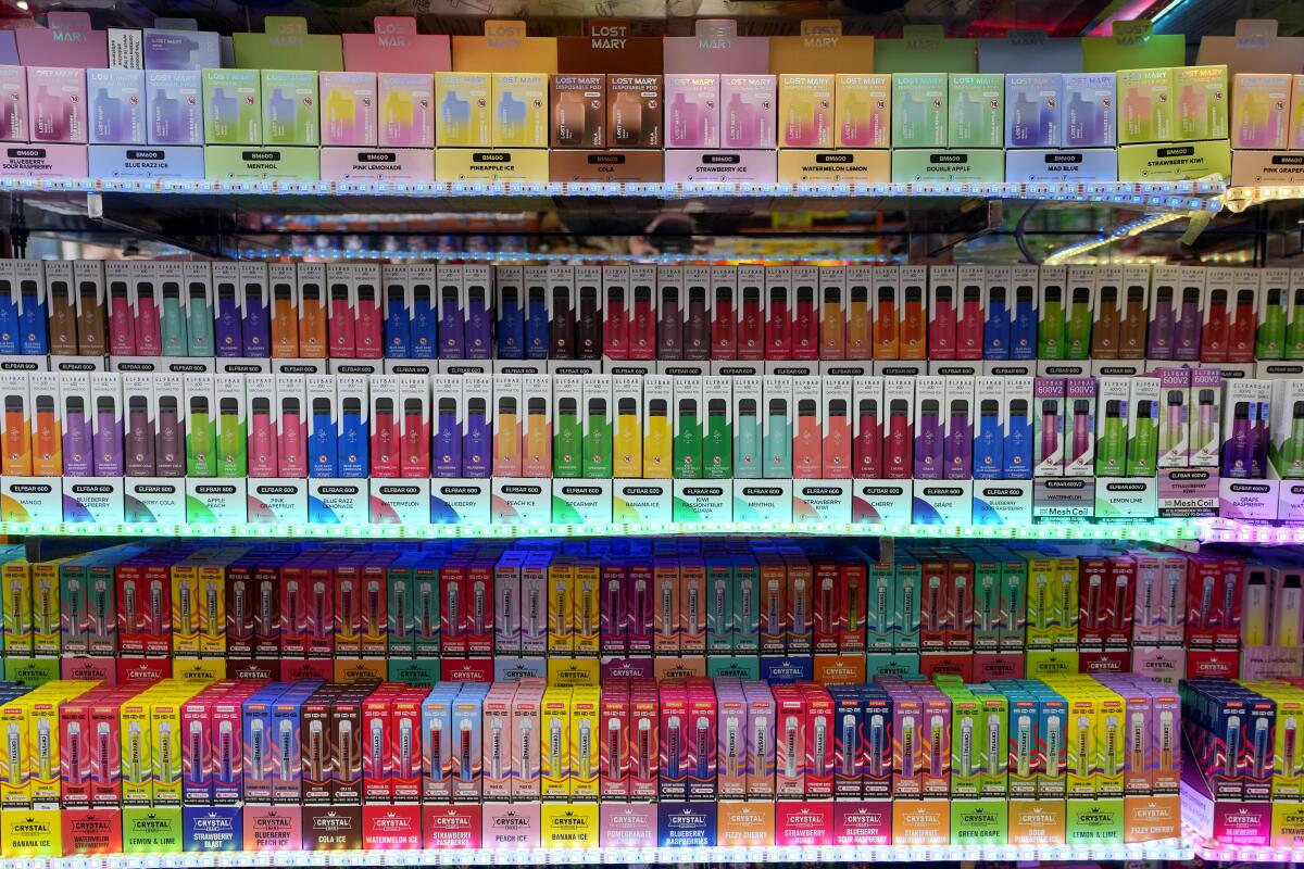 Shelves of colorful disposable vapes on display in a London shop