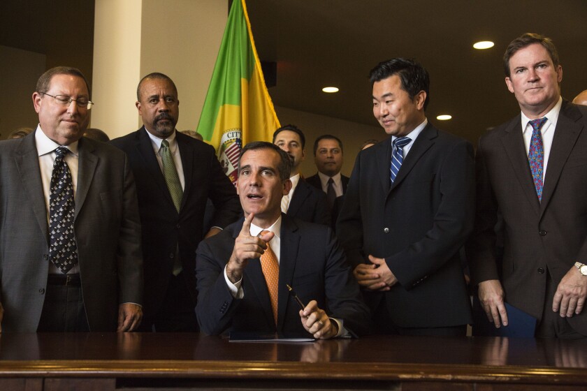 Mayor Eric Garcetti prepares to sign Executive Directive No. 14 at the city's new Emergency Operations Center on Friday.