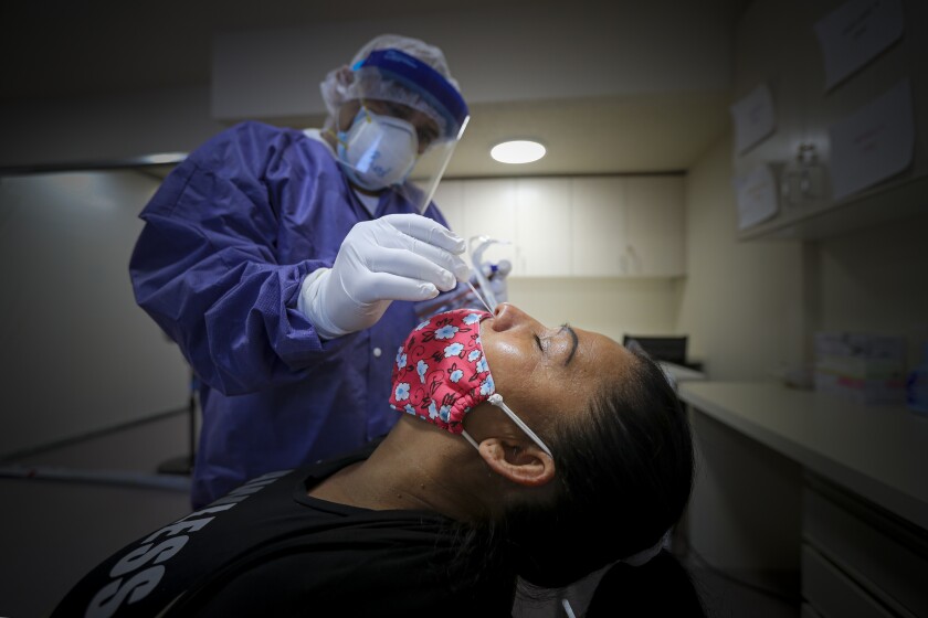 A nurse practitioner conducts a coronavirus test in Los Angeles.