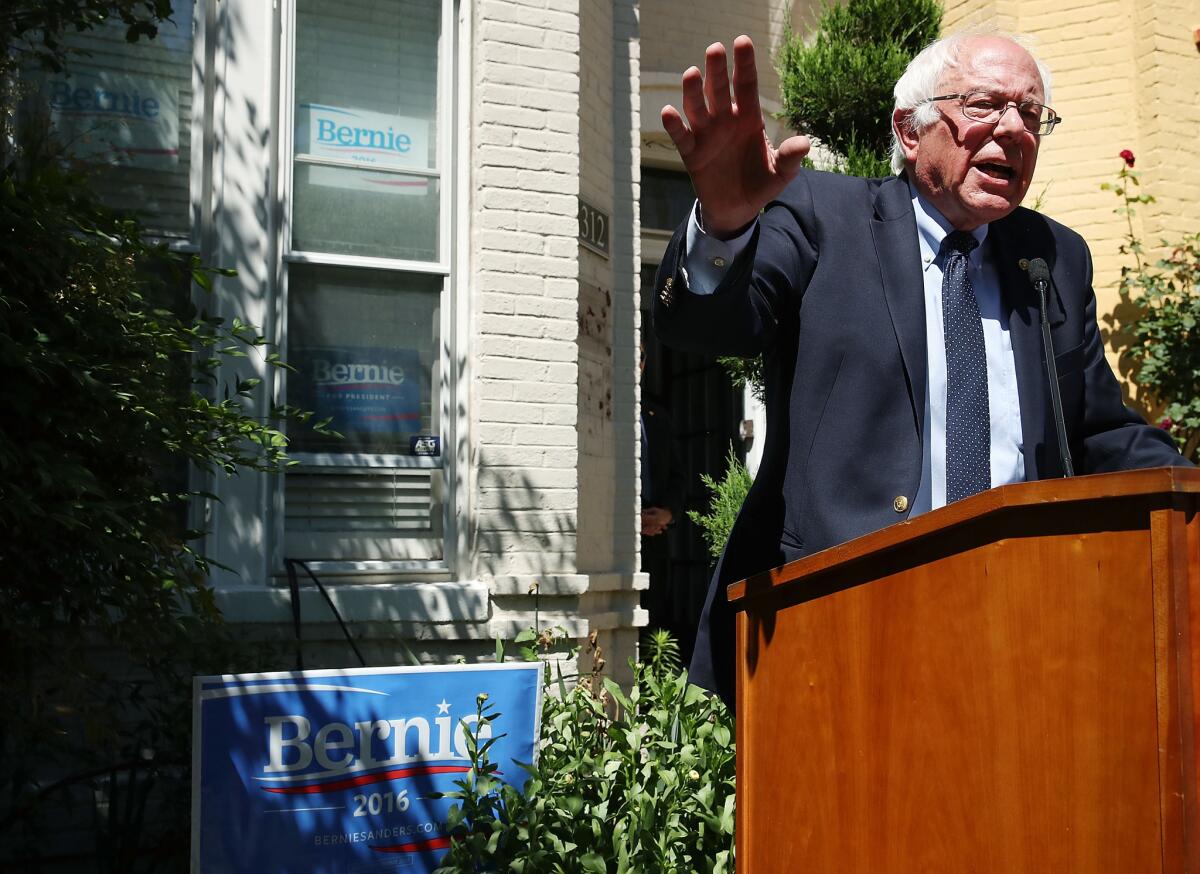 Bernie Sanders speaks to the media outside his Washington campaign headquarters on Tuesday, hours before his meeting with Hillary Clinton.
