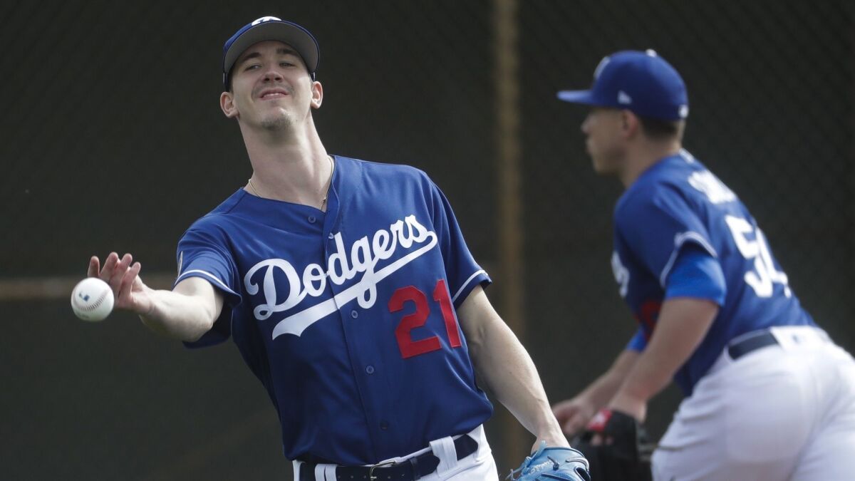 Dodgers pitcher Walker Buehler takes part in a team drill during a spring training practice session at Camelback Ranch on Wednesday.