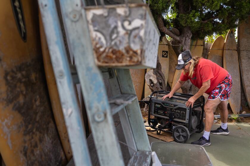 Rancho Palos Verdes, - September 22: Patty Perkinson turns on her new generator at her home where her gas and electricity was shut off due to the landslides in Rancho Palos Verdes on Sunday, Sept. 22, 2024 in Rancho Palos Verdes, . (Jason Armond / Los Angeles Times)