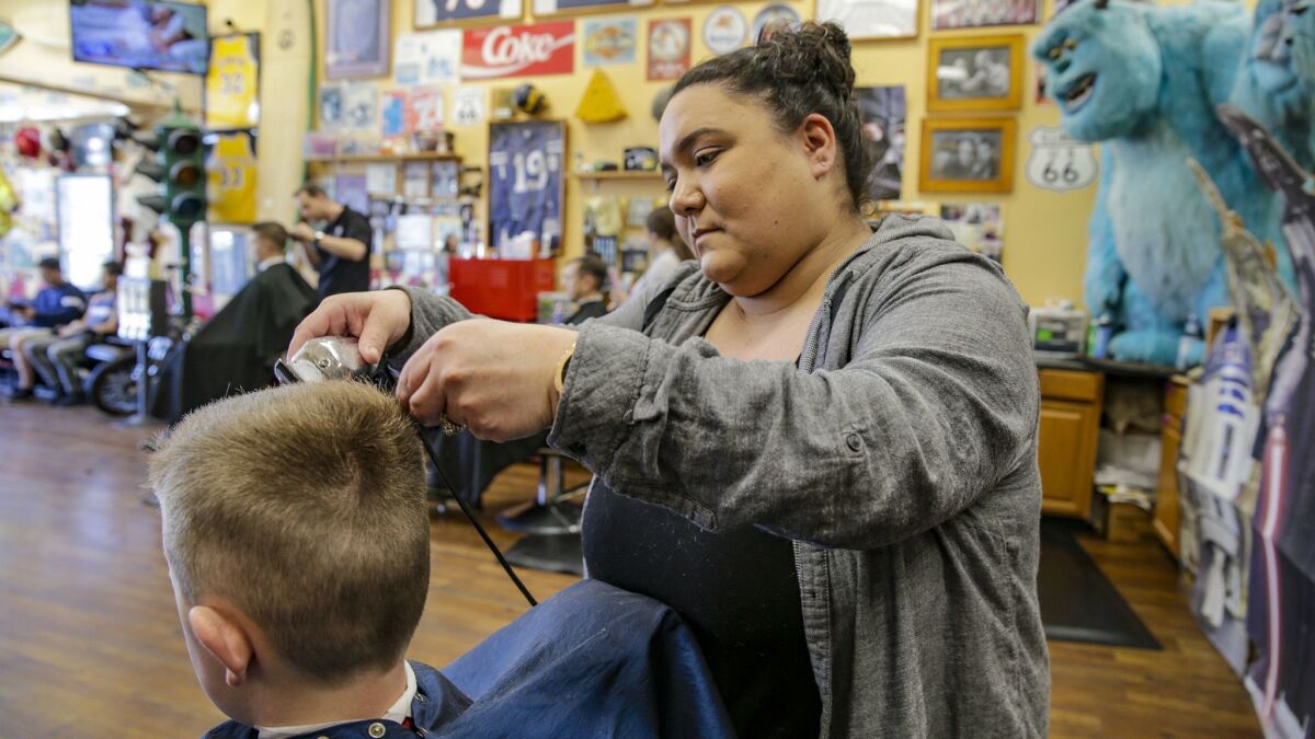 Kristyn Hansen, at Stews Barber Shop in Ladera Ranch, used to work as a contractor. With the Dynamex court ruling, she was classified as an employee.