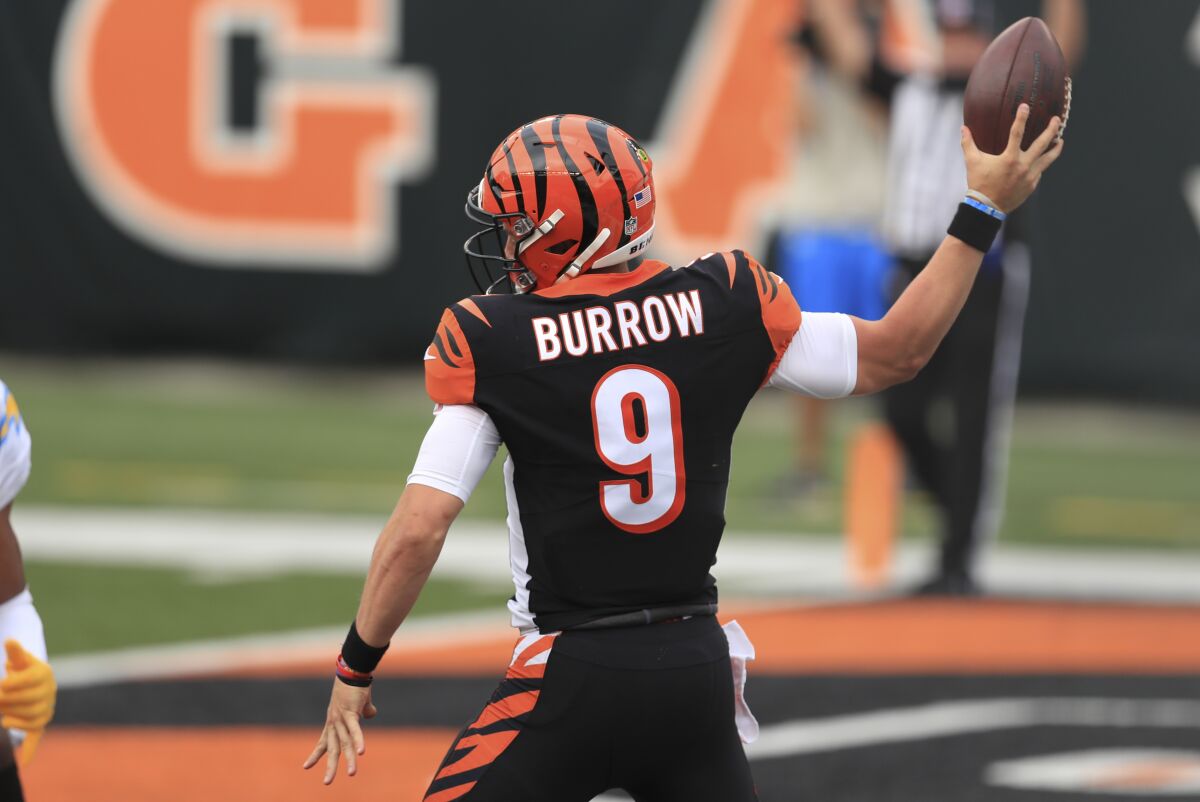 Cincinnati Bengals quarterback Joe Burrow (9) reacts after running for a touchdown during the first half of an NFL football game against the Los Angeles Chargers, Sunday, Sept. 13, 2020, in Cincinnati. (AP Photo/Aaron Doster)