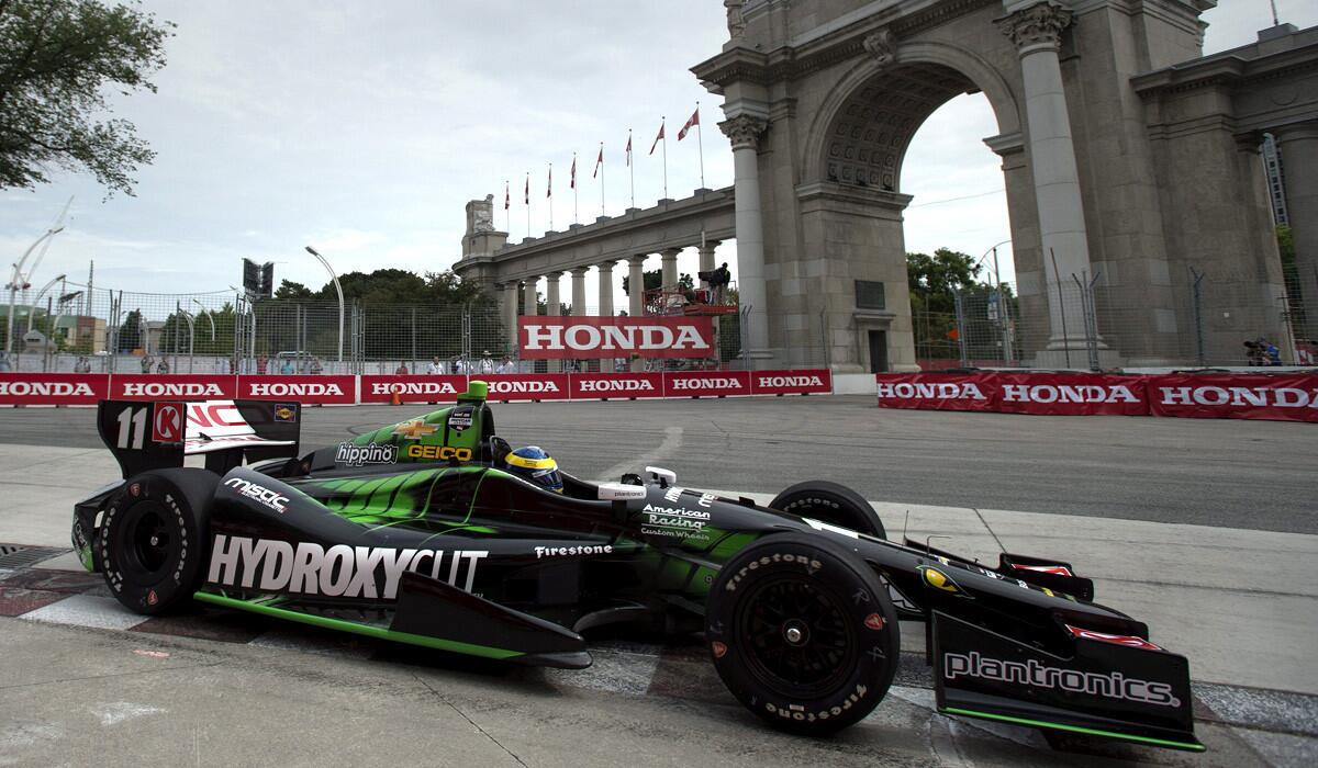 IndyCar driver Sebastien Bourdais guides his car around the track while winning the pole position for the first race of a weekend doubleheader in Toronto.