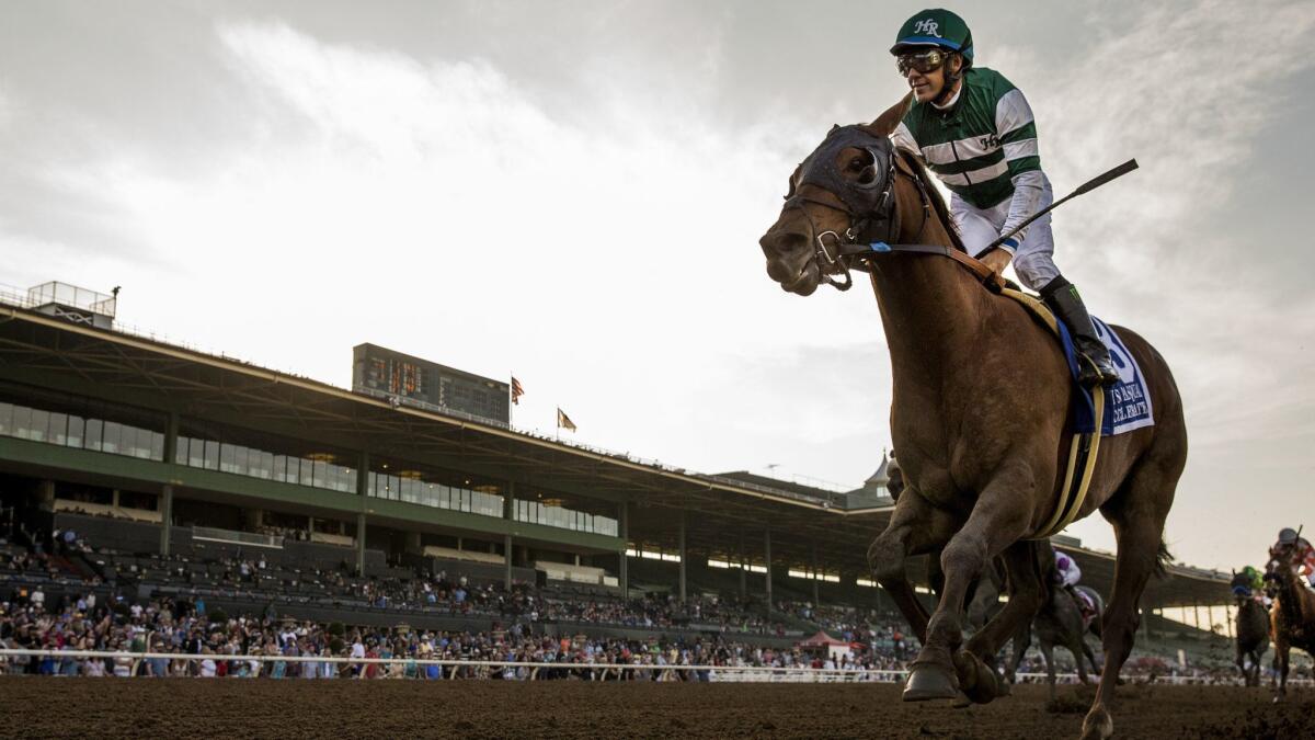 Victor Espinoza smiles as he crosses the wire first in the San Pasqual Stakes at Santa Anita Park on Feb. 3 in Arcadia.