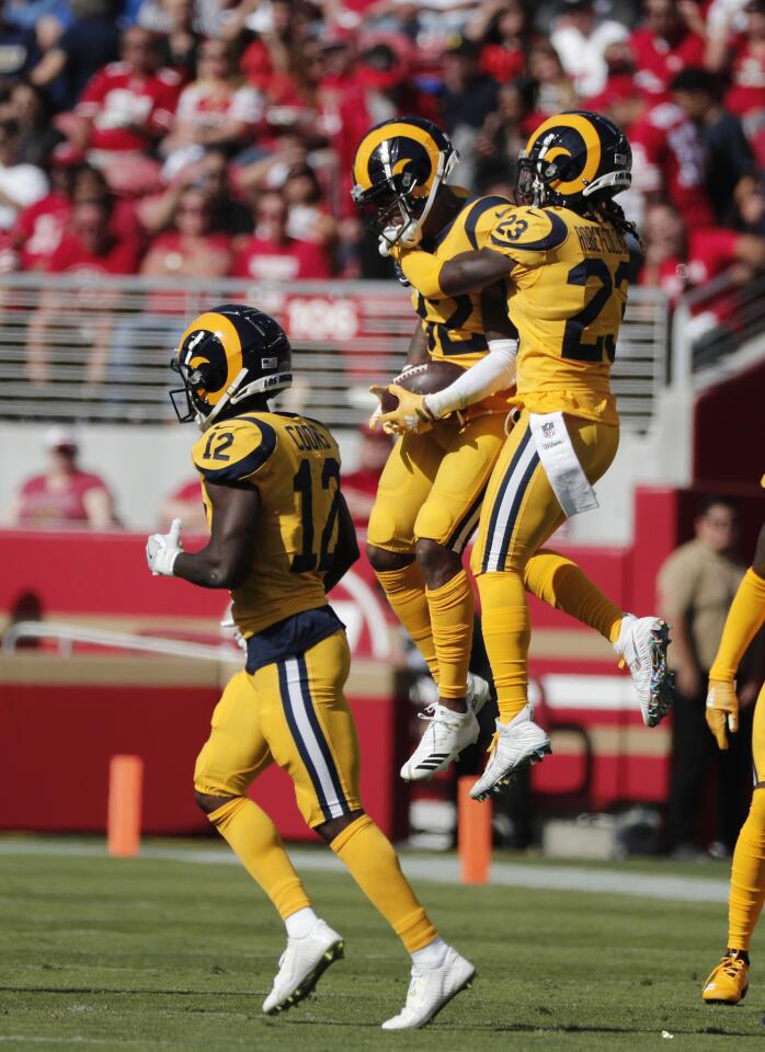 Rams cornerback Troy Hill (32) celebrates with defensive back Nickell Robey-Coleman (23) after intercepting a pass thrown by San Francisco 49ers quarterback C.J. Beathard in the first half at Levi's Stadium on Sunday in Santa Clara.