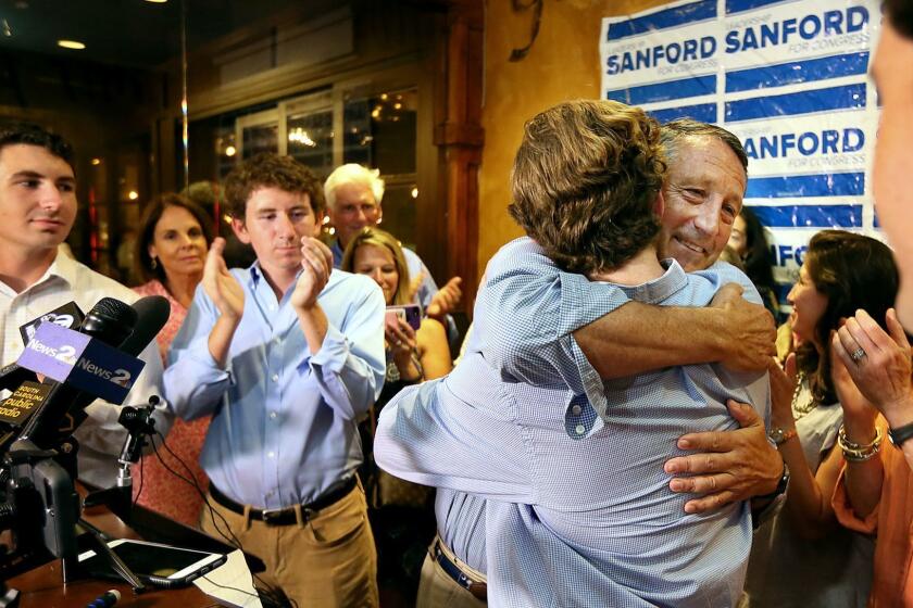 U.S. Rep. Mark Sanford hugged his sons after addressing his supporters at Liberty Tap Room in Mount Pleasant, S.C., Tuesday, June 12, 2018. Sanford lost his first election ever Tuesday, beaten for the Republican nomination for another term in the coastal 1st District around Charleston by state Rep. Katie Arrington. (Wade Spees/The Post And Courier via AP)