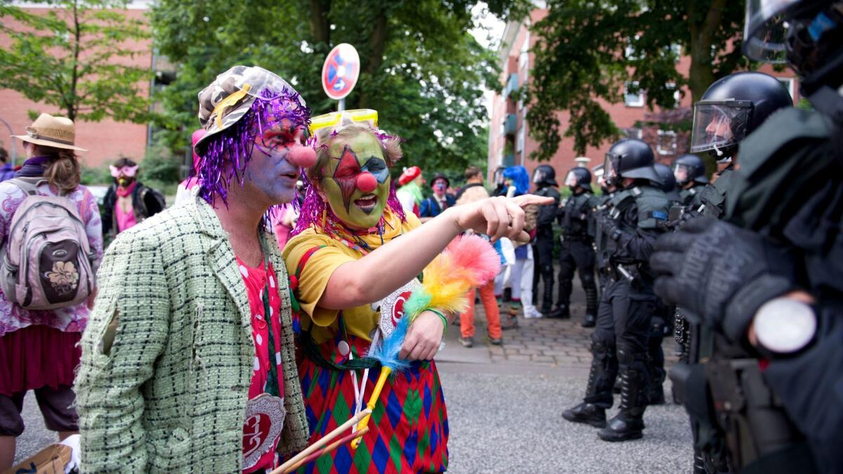 Protesters dressed as clowns talk to police during a demonstration against the G-20 summit in Hamburg, Germany on July 7.