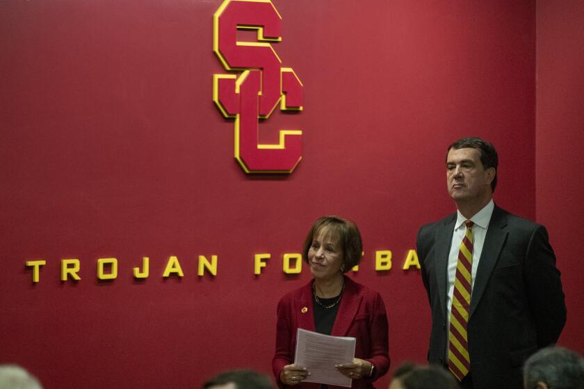 LOS ANGELES, CALIF. -- THURSDAY, NOVEMBER 7, 2019: USC President Carol L. Folt, left, waits with new USC athletic director Mike Bohn, right, during news conference on the USC campus in Los Angeles, Calif., on Nov. 7, 2019. (Brian van der Brug / Los Angeles Times)