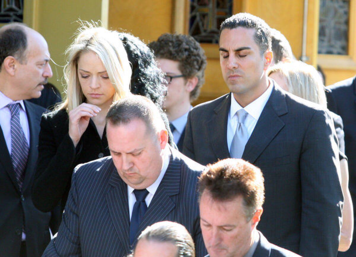 Assemblyman Mike Gatto, with his wife Danielle, mourn as they follow the casket of Mike Gatto's father Joseph Anthony Gatto at funeral services at Our Mother of Good Counsel Church in Los Angeles on Monday, November 25, 2013. Joe Gatto was killed in his home during an apparent home invasion robbery. (Tim Berger/Staff Photographer)