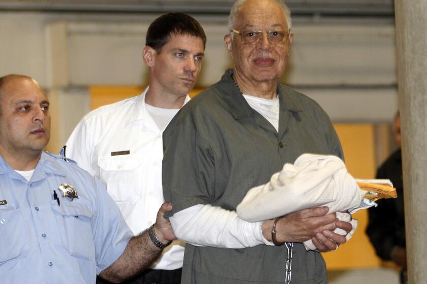 Dr. Kermit Gosnell is escorted to a waiting police van upon leaving the Criminal Justice Center in Philadelphia.