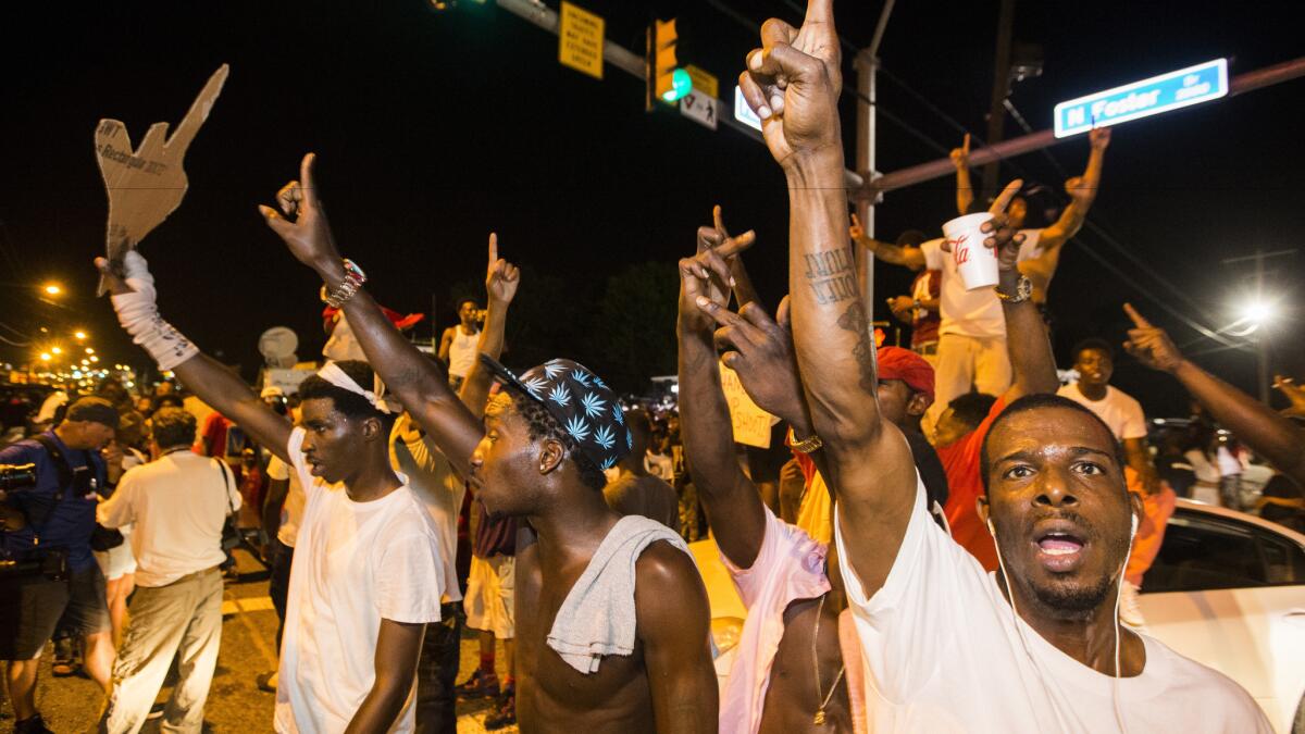 Protesters block traffic and dance on cars July 6, 2016, near the Triple S Food Mart where Alton Sterling was shot and killed in Baton Rouge, La.