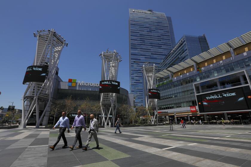 LOS ANGELES, CA MAY 7, 2018: People walk through L.A. Live in Los Angeles, CA during lunch hour May 7, 2018. A $1.2 billion proposal to substantially expand the Los Angeles Convention Center and add a new tower to the J.W. Marriott hotel, seen in background, was announced Monday. Los Angeles entertainment giant AEG filed a proposal with the city to make the downtown convention center one of the biggest in the West. (Francine Orr/ Los Angeles Times)