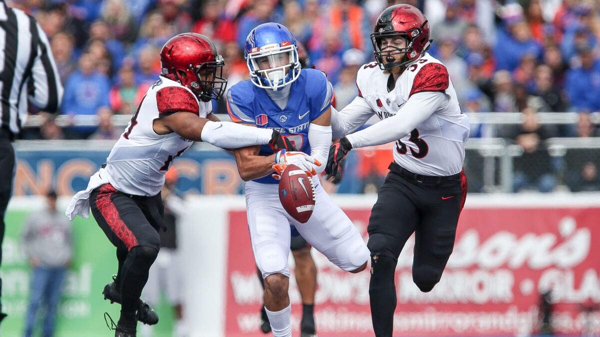 Boise State wide receiver Sean Modster has a pass knocked away by San Diego Sate safeties Tariq Thompson and Parker Baldwin during Saturday's game at Albertsons Stadium.