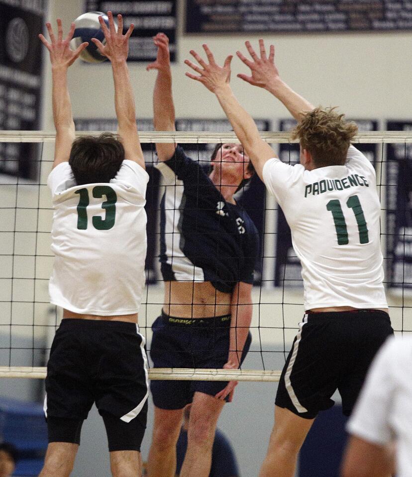 Flintridge Prep's AJ Nicassio hits a particularly special kill against Providence's Conrad Davis and Carl Menke in a Prep League volleyball match at at Flintridge Preparatory School on Tuesday, March 26, 2019. This was Nicassio's 1,000th kill over his high school volleyball career. Flintridge Prep won the match 3-0.