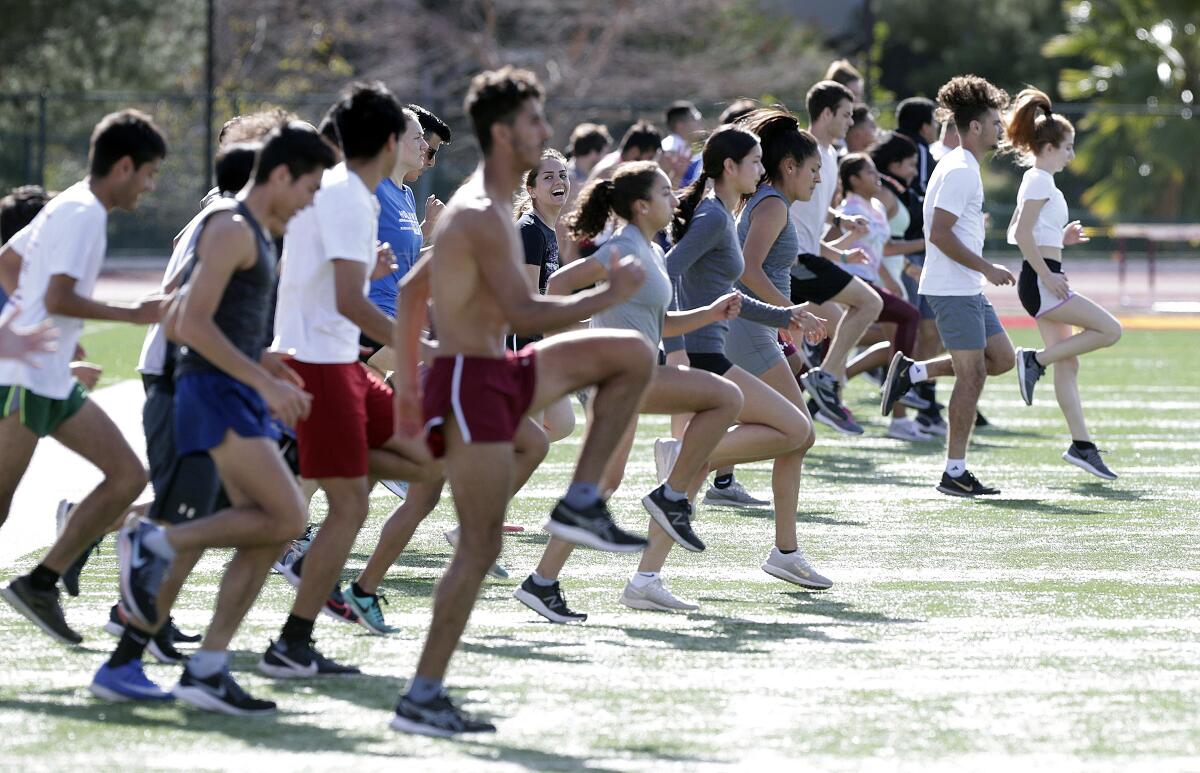 The Glendale Community College track and field athletes warm up during a recent practice.