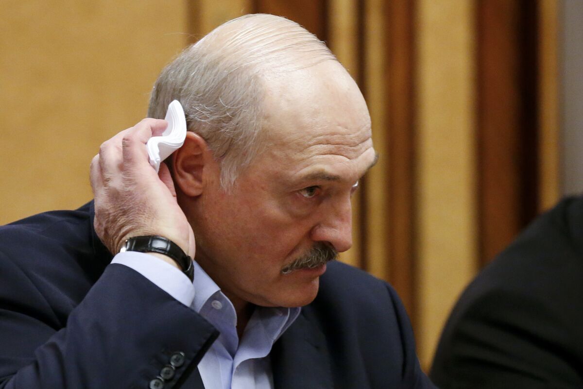 FILE In this file photo taken on Friday, Feb. 7, 2020, Belarusian President Alexander Lukashenko listens to Russian President Vladimir Putin during their meeting in the Black sea resort of Sochi, Russia. Lukashenko faces a perfect storm as he seeks a sixth term in the election held Sunday, Aug. 9, 2020 after 26 years in office. Mounting public discontent over the worsening economy and his government’s bungled handling of the coronavirus pandemic has fueled the largest opposition rallies since the Soviet collapse. (AP Photo/Alexander Zemlianichenko, Pool, File)