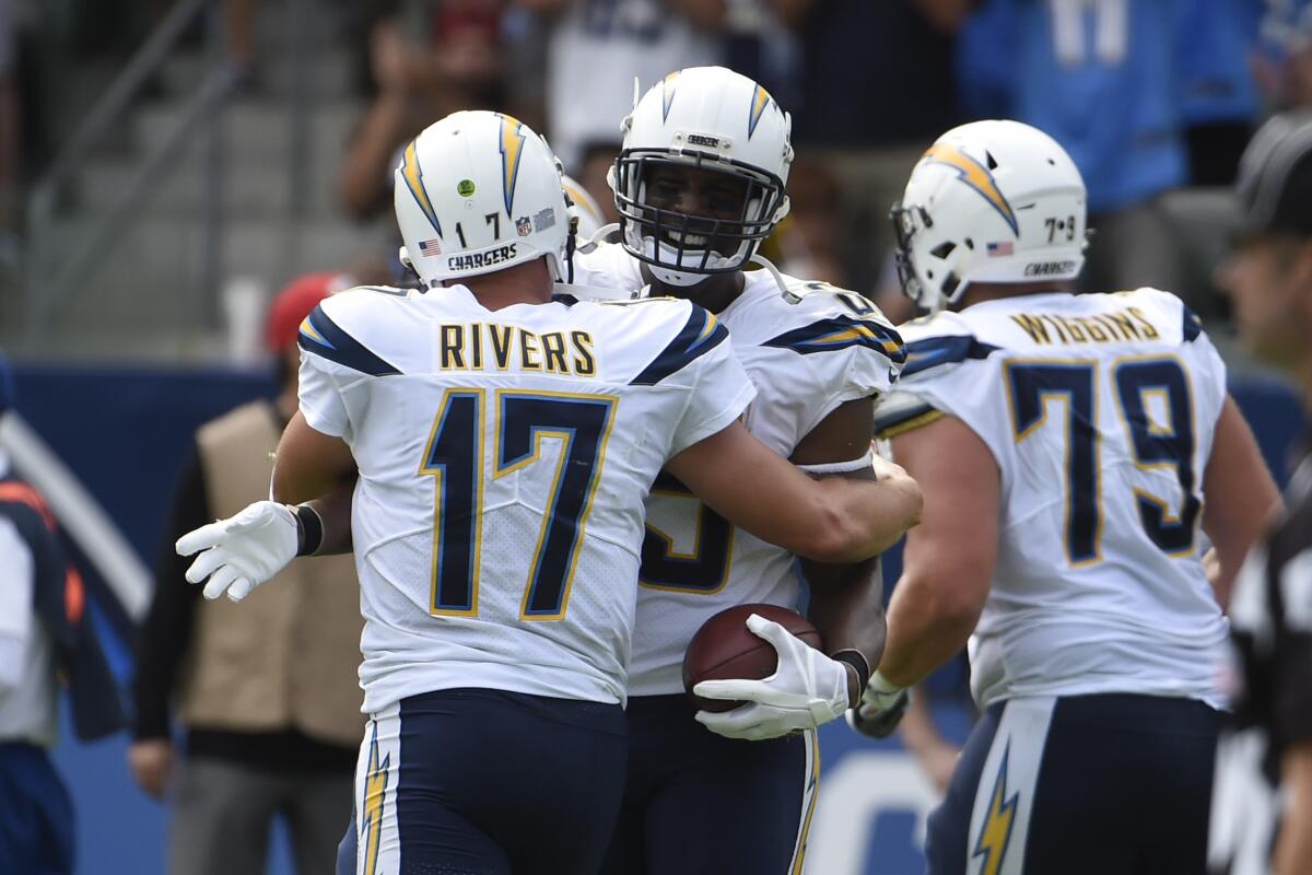 Chargers  quarterback Philip Rivers (17) hugs Antonio Gates after the tight end's touchdown catch in 2017. 