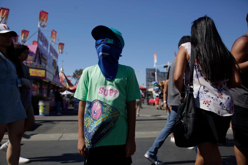 COSTA MOSA, CALIF. - JULY 12, 2019: Jericho Rodriguez, 8, wears a mask to prevent a sunburn at the annual Orange County Fair in Costa Mosa, Calif. on Friday, July 12, 2019. (Liz Moughon / Los Angeles Times)