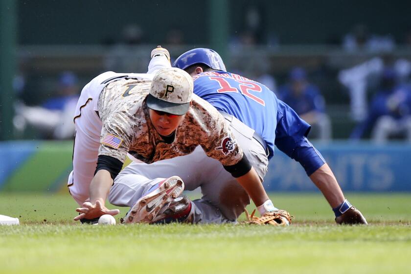 The Cubs' Kyle Schwarber steals second base in front of Pittsburgh Pirates Jung Ho Kang during the first inning.