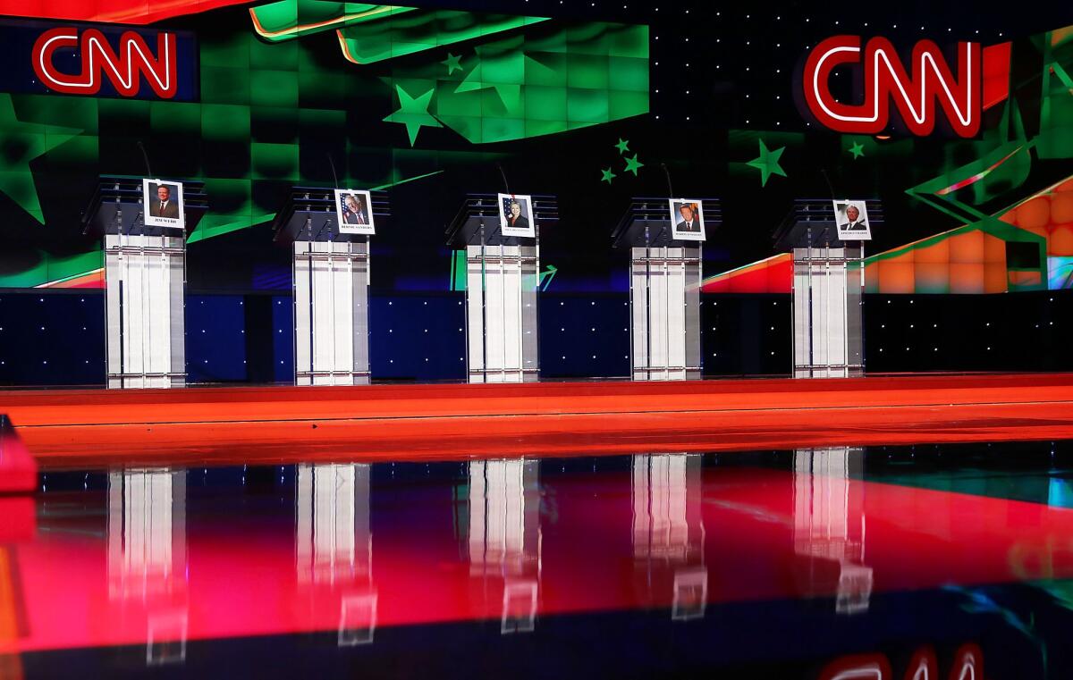 Photographs of Democratic presidential candidates hang on their debate lecterns a day before the debate at the Wynn Las Vegas.