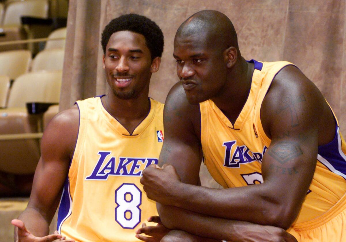 Lakers teammates Kobe Bryant, left, and Shaquille O'Neal take part in the team's media day in Santa Barbara on Oct. 5, 1999.