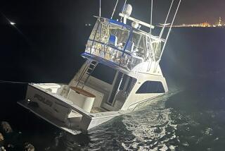 A photo shows the sinking Four Kings boat in the Long Beach harbor.