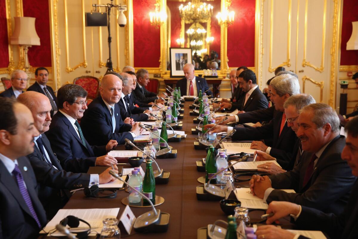 U.S. Secretary of State John Kerry, fourth from right, attends a meeting in London on Tuesday hosted by British Foreign Secretary William Hague, fourth from left. The meeting at Lancaster House was of the "London 11," from the Friends of Syria Core Group, aimed at ending the civil war in Syria.