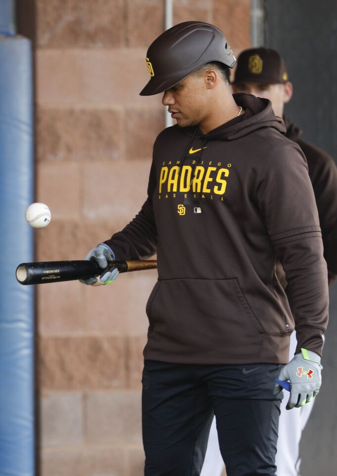 Padres right fielder Juan Soto (22) bounces a ball on his bat during a spring training practice at Peoria Sports Complex on Friday.