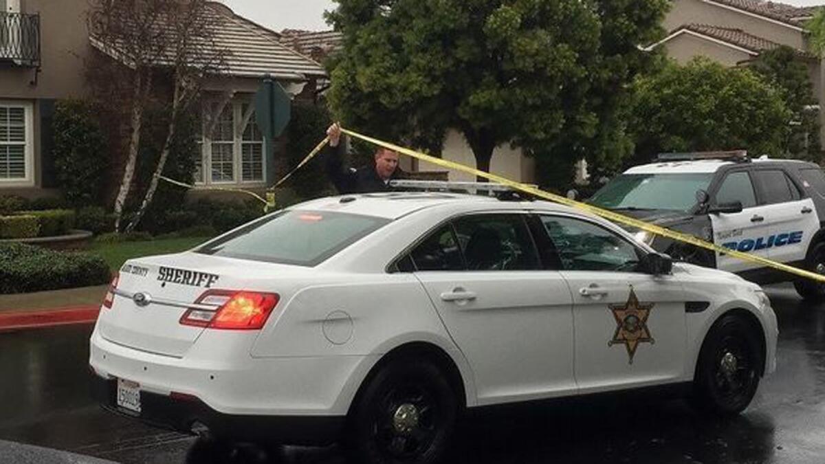 Authorities gather Thursday morning at the homicide scene on Palazzo in Bonita Canyon.