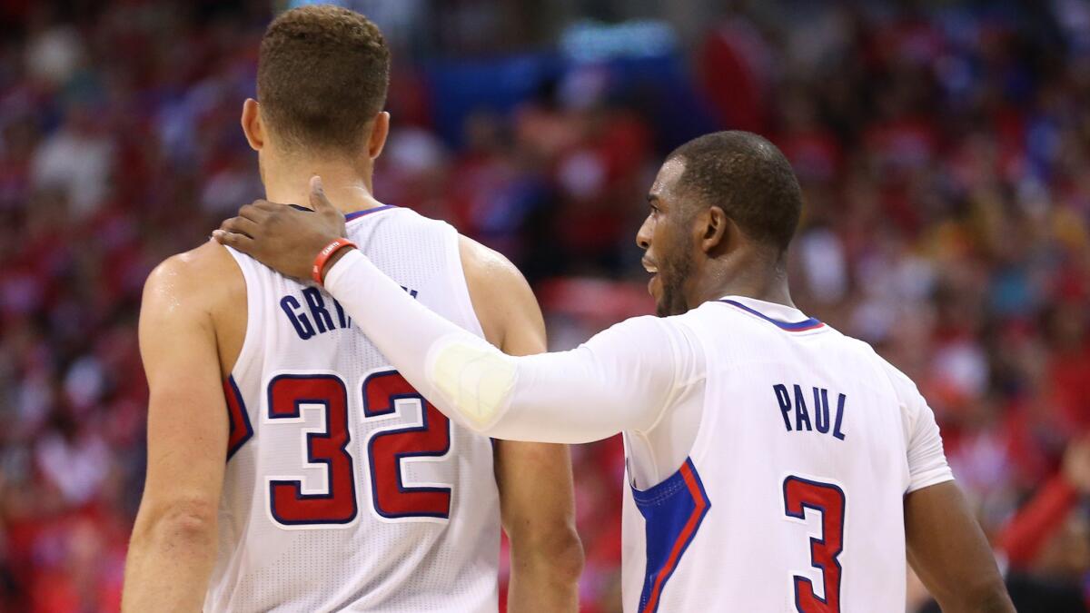 Clippers teammates Blake Griffin, left, Chris Paul walk together on the court during the team's series-clinching win over the Golden State Warriors in the opening round of the NBA playoffs Saturday. The Clippers open their Western Conference semifinal series against the Oklahoma City Thunder on Monday.