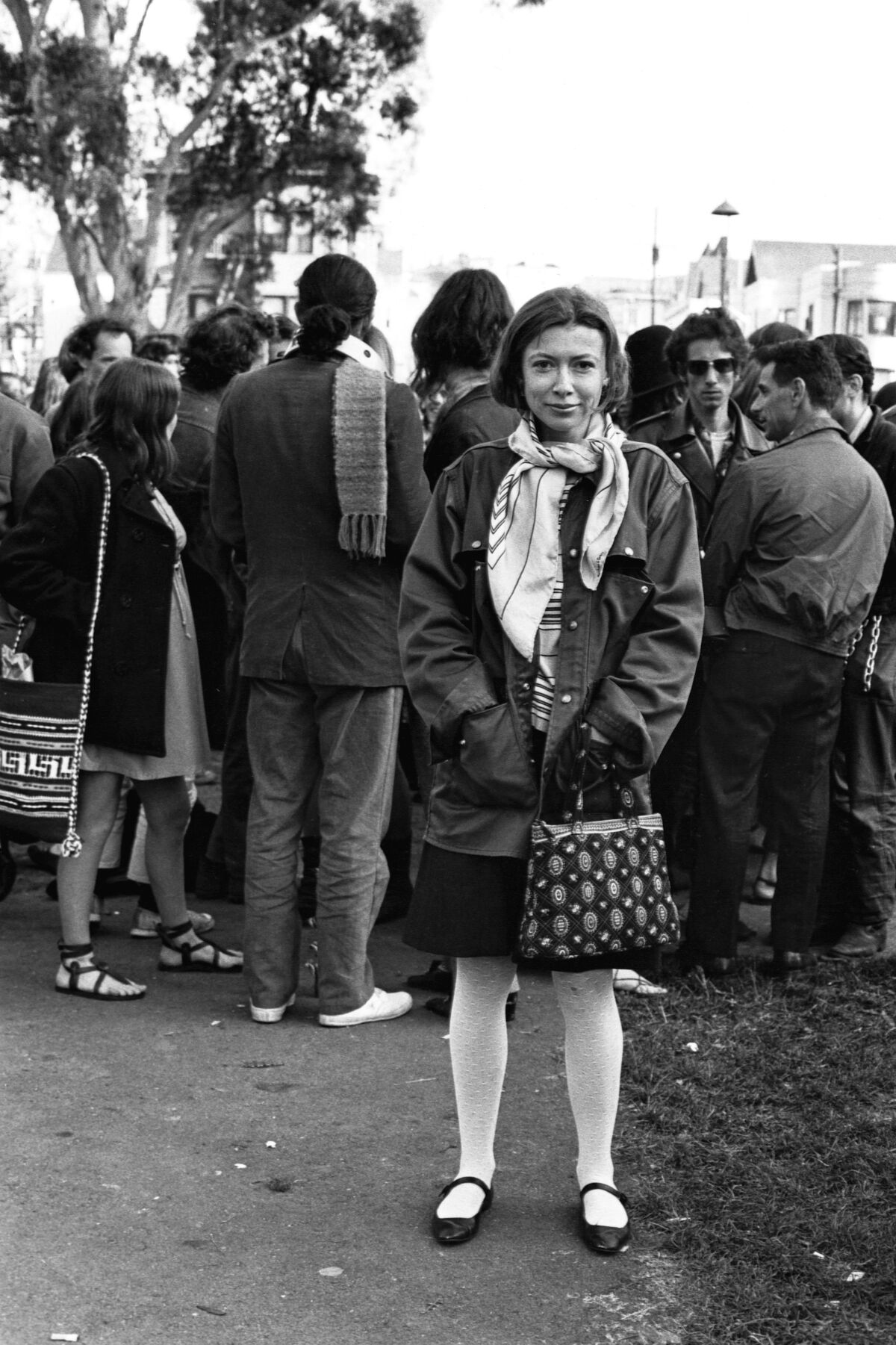 Didion stands among the hippies in Golden Gate Park, April 1967.